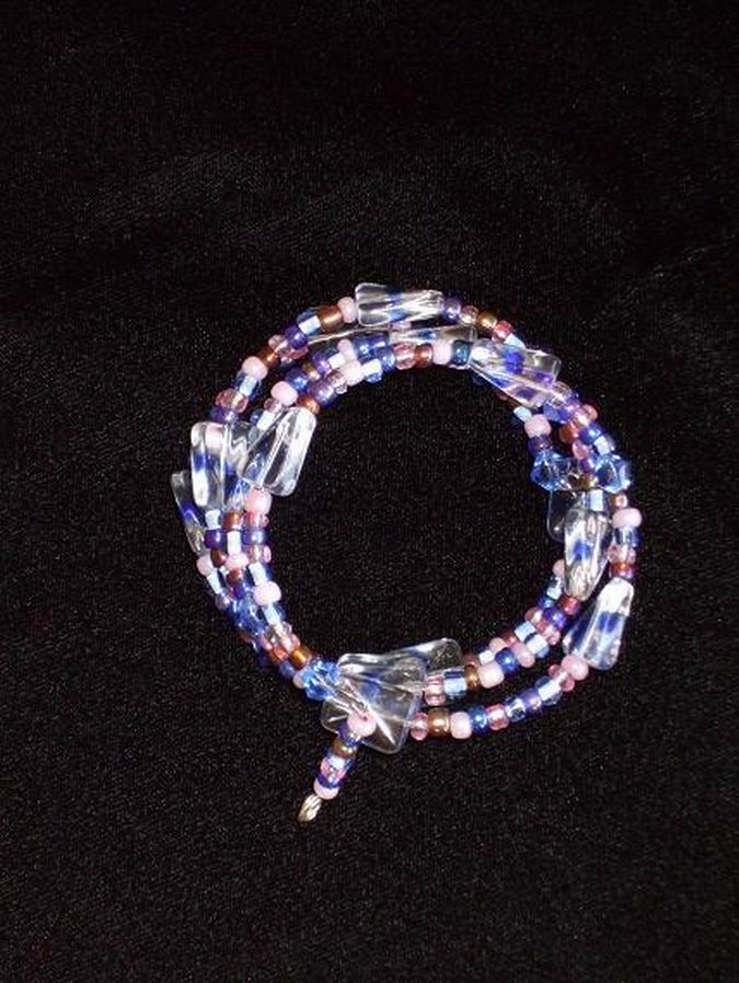 Blue, amber, and pink glass beads with larger blue/clear accent beads. Silver memory wire.  (C120P116) - Click for more details