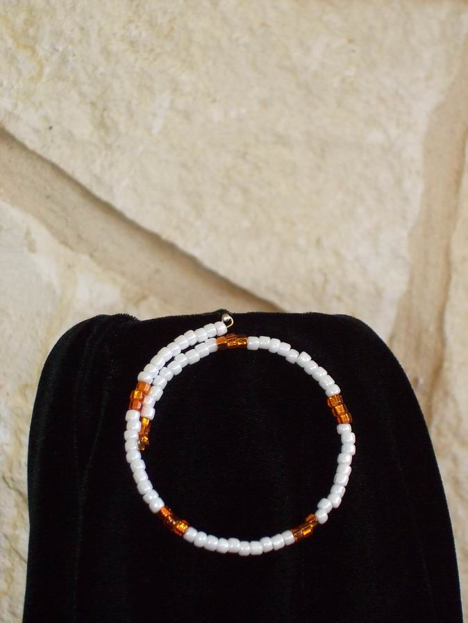 White glass beads accented with orange glass beads. Gold memory wire.  (C120P123) - Click for more details