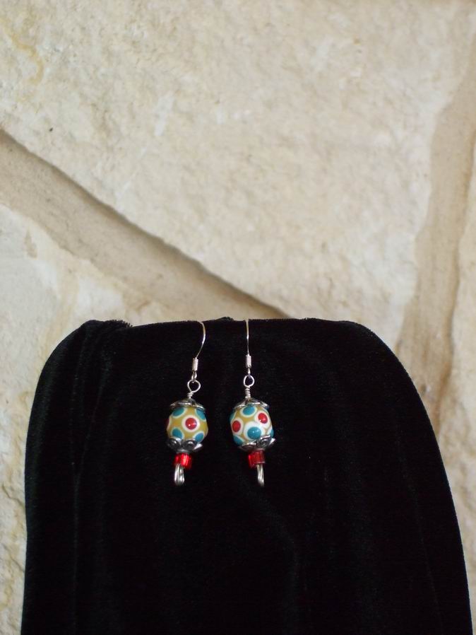 Hand-blown multi colored glass beads, silver caps, and red glass beads on sterling silver ear wires.  (C120P156) - Click for more details