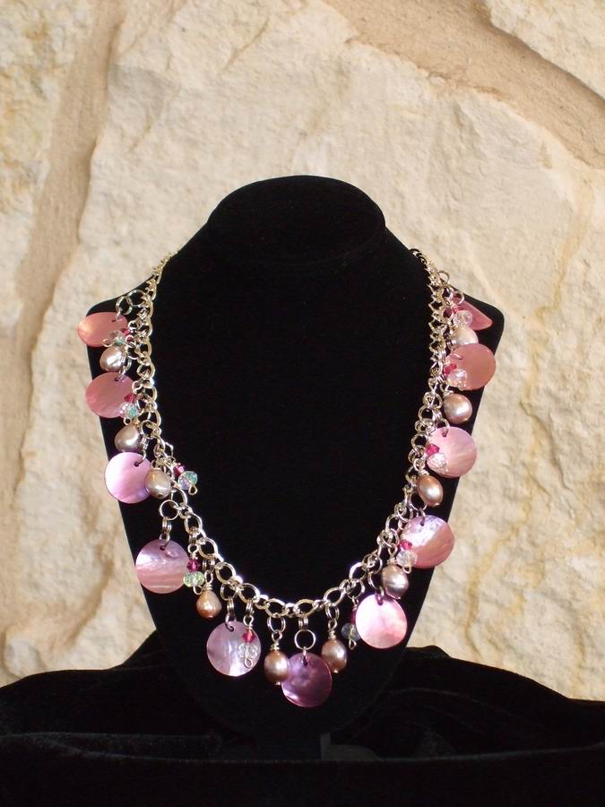 Pink mother of pearl disks accented with freshwater pearls and Swarovski Crystals.  (C120P174) - Click for more details