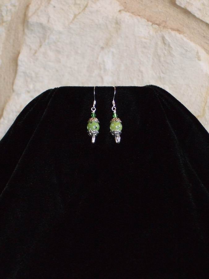 Green Czech Glass with silver caps. Sterling silver wire and ear wires.  (C120P176) - Click for more details