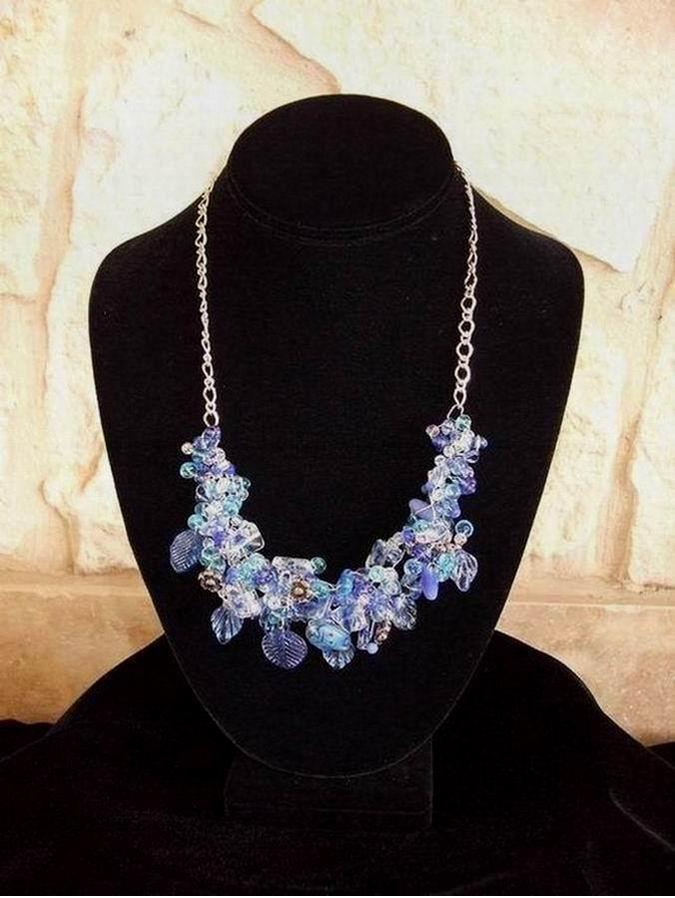 Multiple shades of blue glass beads accented by large glass Lady Bug in center and silver flowers.  (C120P66) - Click for more details