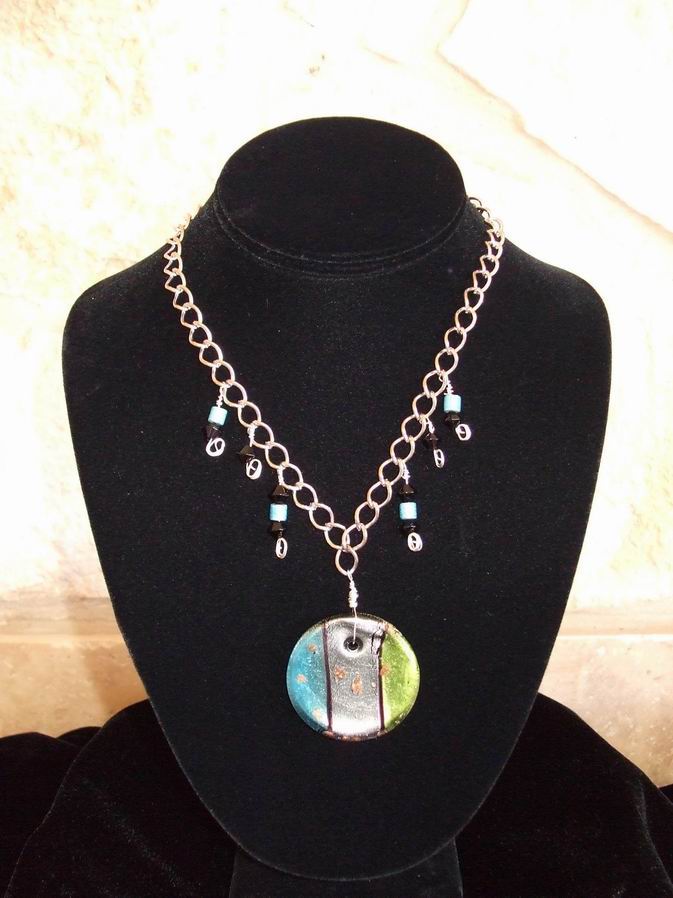 Glass pendant on silver chain. Necklace is accented with aqua beads and black Swarovski Crystals.  (C120P73) - Click for more details