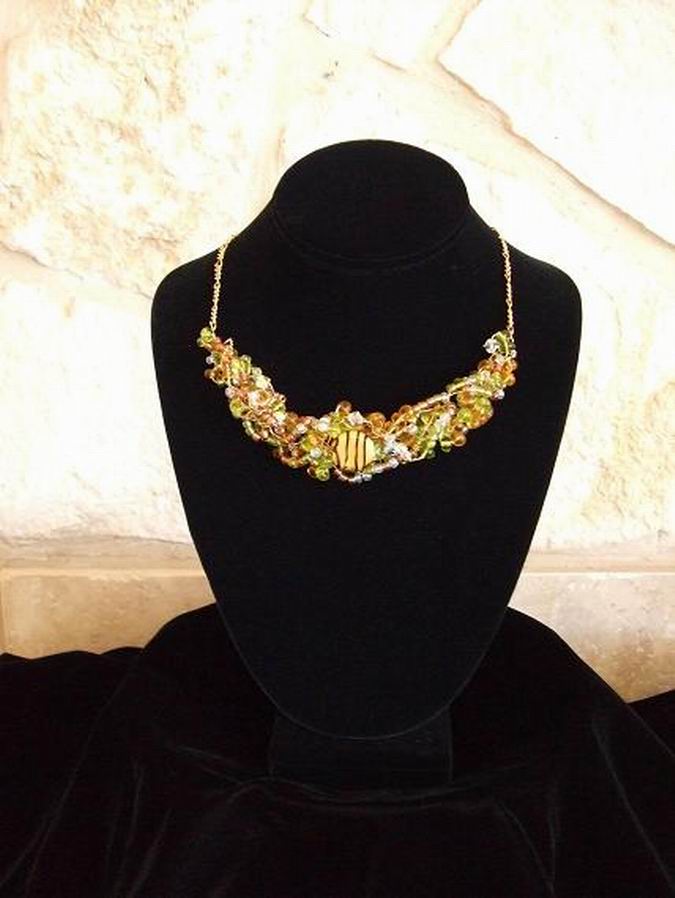 Swarovski Crystals, glass beads of amber, soft lime green, & clear with center glass 