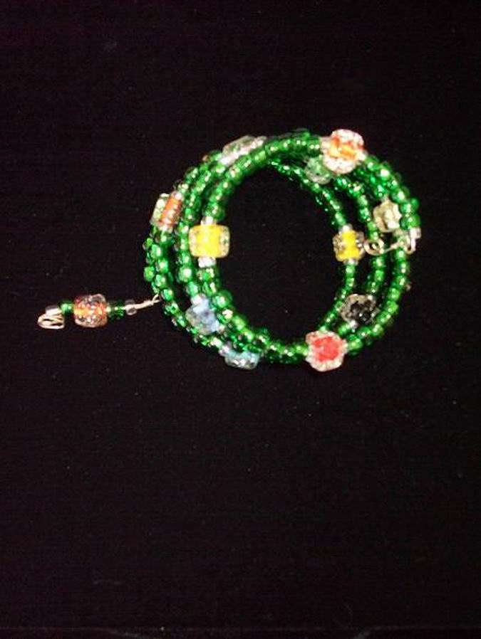 Green glass accented with hand-blown beads of orange, blue, red, yellow, black & white.  (C120P83) - Click for more details